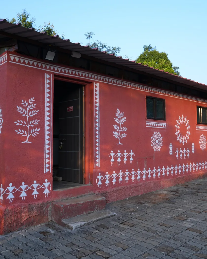 The campers’ washroom block at the farm, painted with white folk patterns.