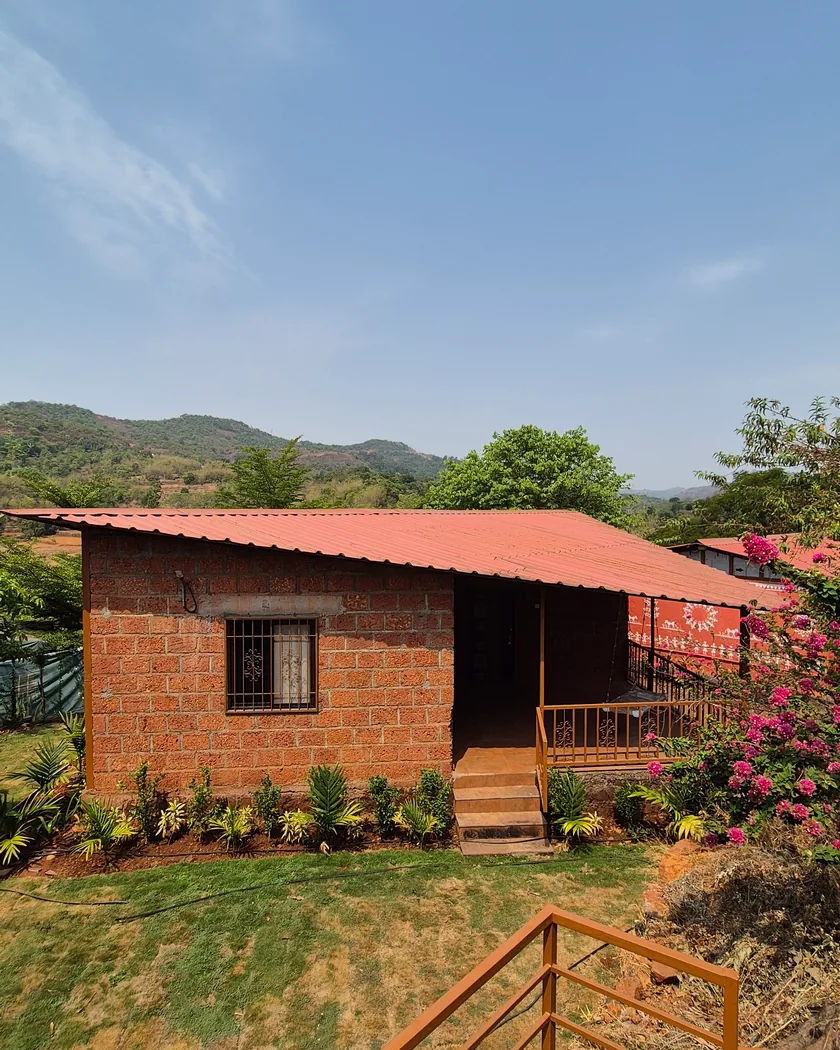 A cottage verandah framed by bougainvillea in the farmstay garden near Rajgad Fort.