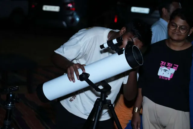 A guest lining up a telescope on the farm after dark.